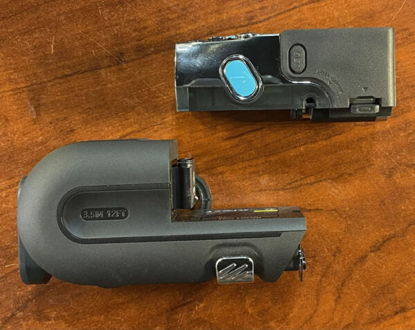 Disassembled Mileseey Xtape1 laser module separated from the black plastic tape measure housing.